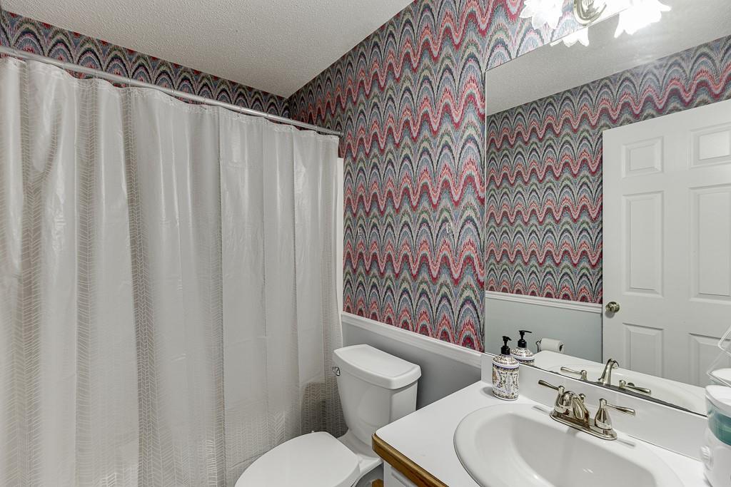 1262 Bowman Road Lawrenceville, GA 30045 - Photo 18 of 32 a bathroom with a sink toilet and shower