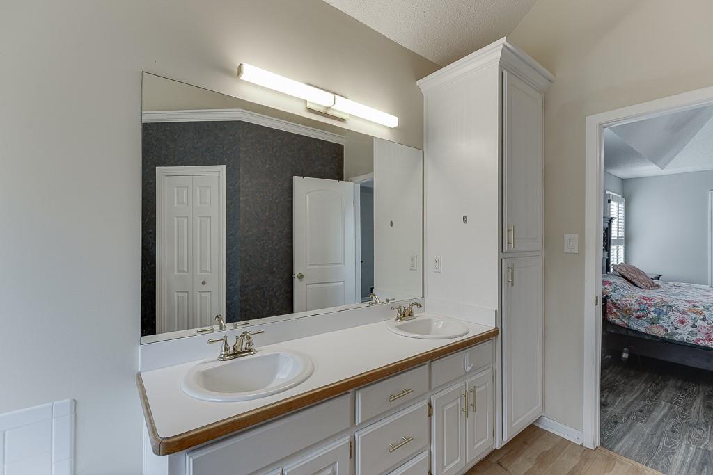 1262 Bowman Road Lawrenceville, GA 30045 - Photo 20 of 32 a en suite bathroom with a double vanity sink and mirror