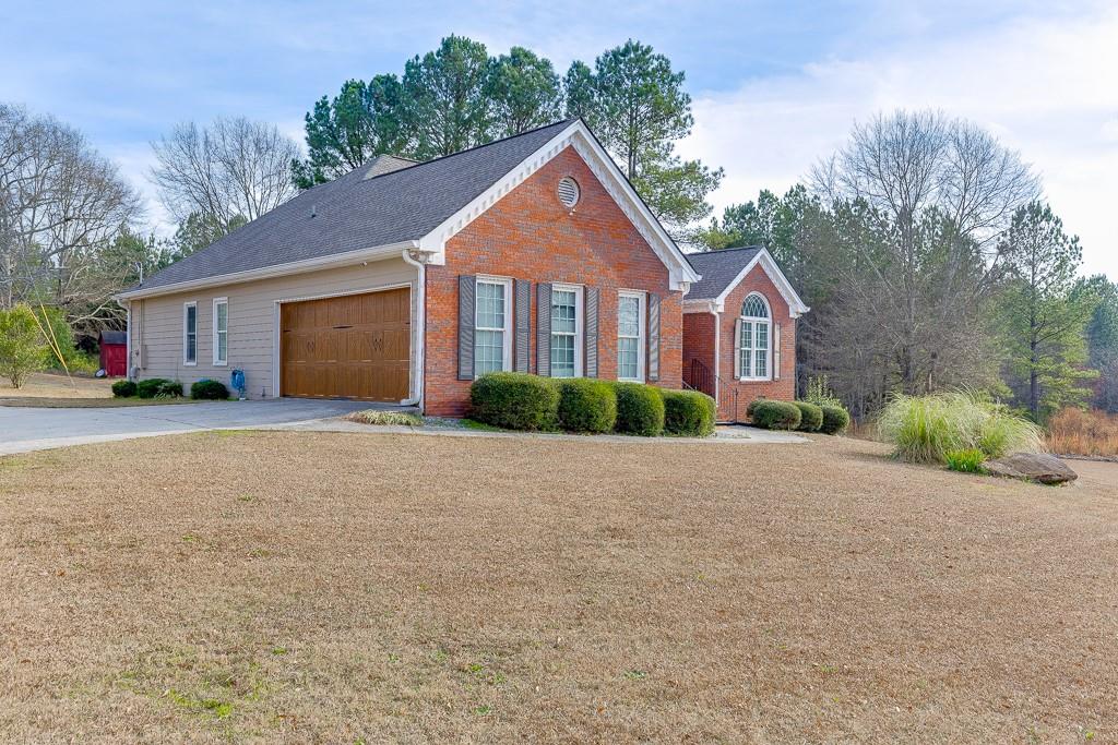 1262 Bowman Road Lawrenceville, GA 30045 - Photo 2 of 32 a front view of a house with a yard and garage