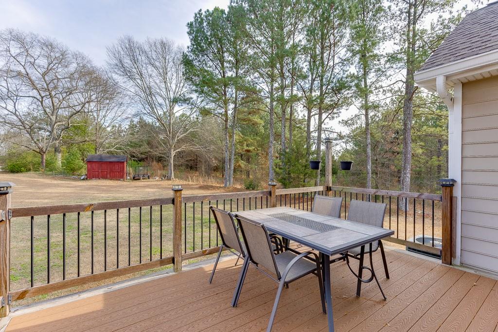 1262 Bowman Road Lawrenceville, GA 30045 - Photo 24 of 32 a view of a patio with table and chairs and wooden floor