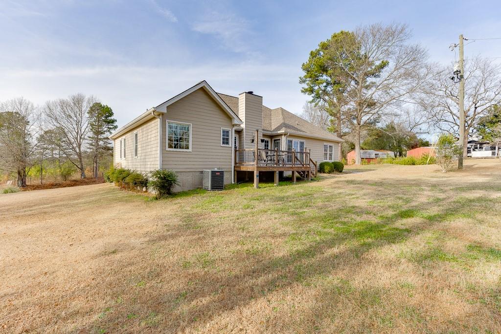 1262 Bowman Road Lawrenceville, GA 30045 - Photo 26 of 32 a view of a house with a yard and large trees