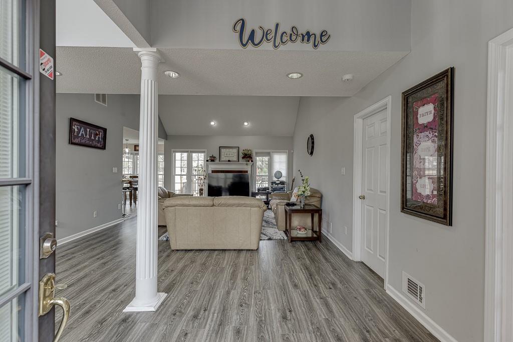1262 Bowman Road Lawrenceville, GA 30045 - Photo 4 of 32 a view of kitchen with kitchen island microwave stove refrigerator and wooden floor