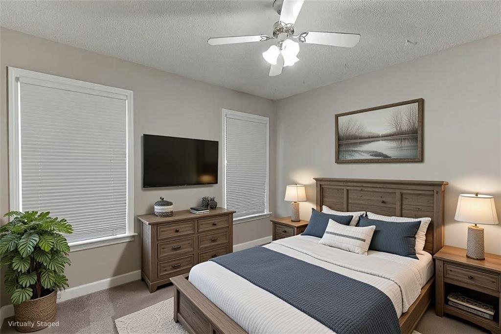 1262 Bowman Road Lawrenceville, GA 30045 - Photo 7 of 32 a bedroom with a bed and a flat screen tv