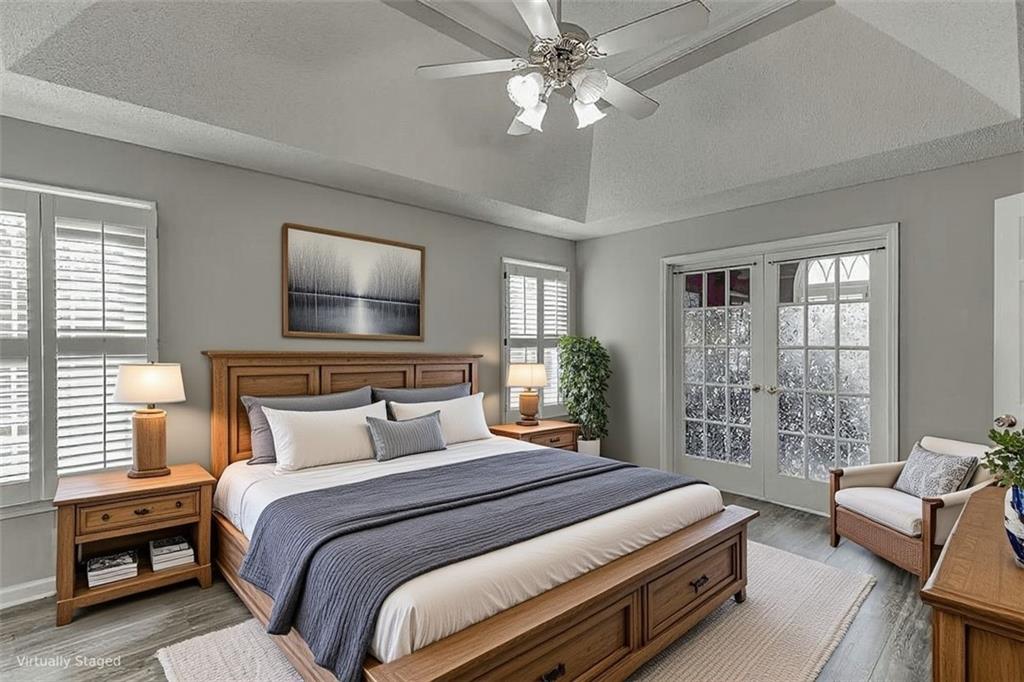 1262 Bowman Road Lawrenceville, GA 30045 - Photo 8 of 32 a bedroom with a large bed and a chandelier