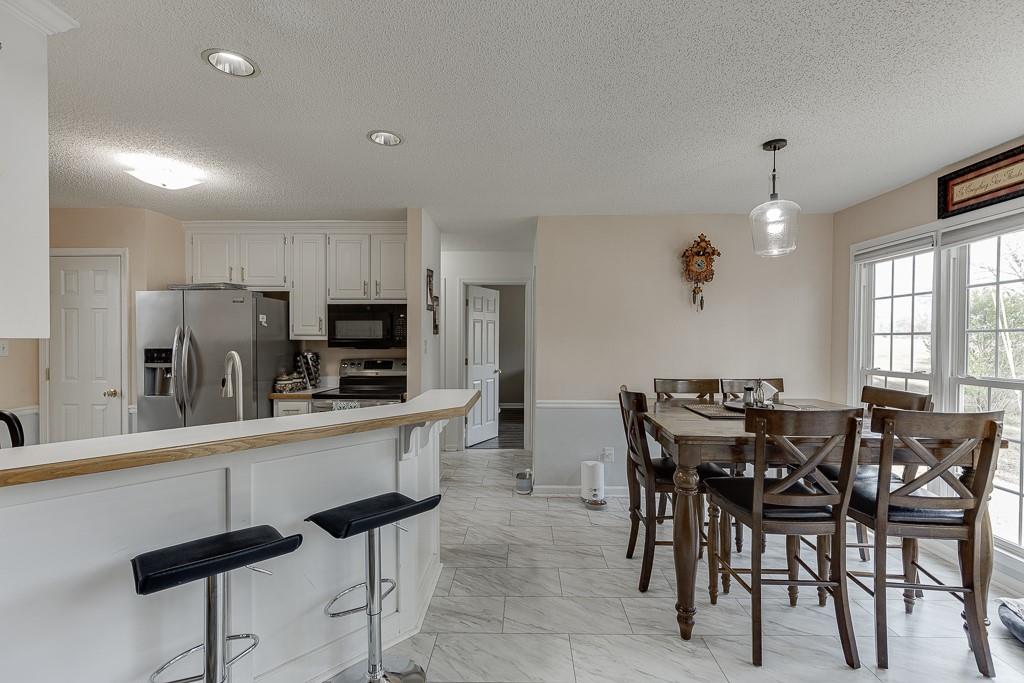 1262 Bowman Road Lawrenceville, GA 30045 - Photo 10 of 32 a large kitchen with a table and chairs