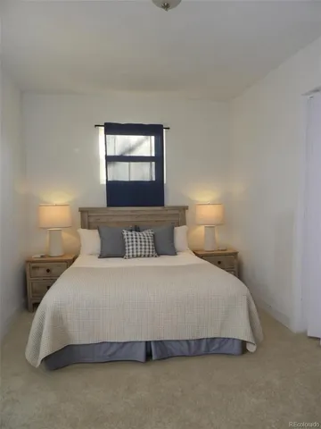 a bedroom with a bed and a lamp