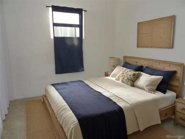 a bedroom with a bed and a window