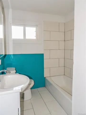 a bathroom with a sink a toilet and bathtub