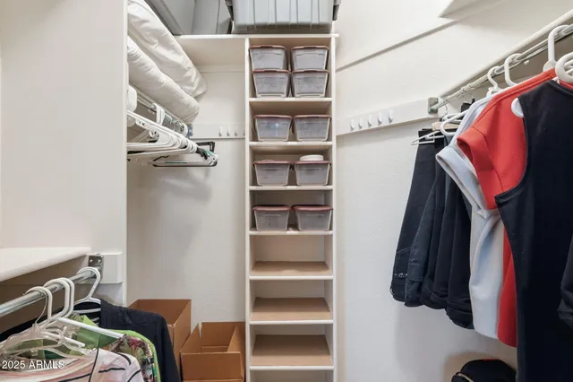 a large bedroom with a large bed and dresser with mirror