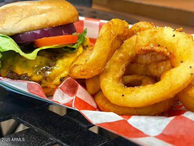 a patio with a table and chairs and potted plants