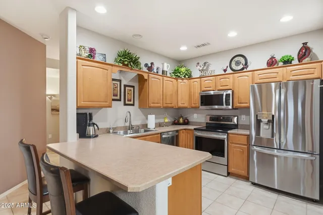 a living room with furniture kitchen view and a chandelier