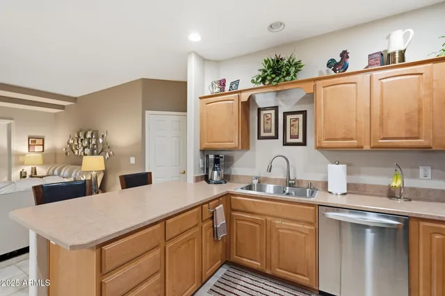 a kitchen with stainless steel appliances granite countertop a refrigerator stove microwave and sink