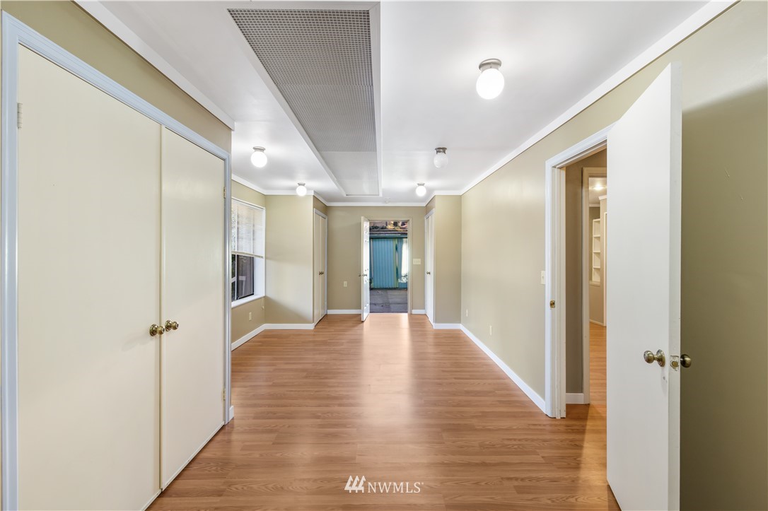 2012 Jones Circle Southeast Renton, WA 98055 - Photo 17 of 25 a view of a hallway with wooden floor and a bathroom