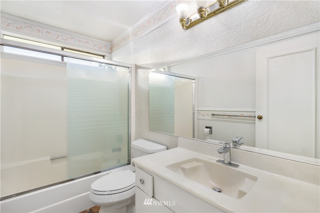 2012 Jones Circle Southeast Renton, WA 98055 - Photo 22 of 25 a bathroom with a sink mirror bathtub and toilet