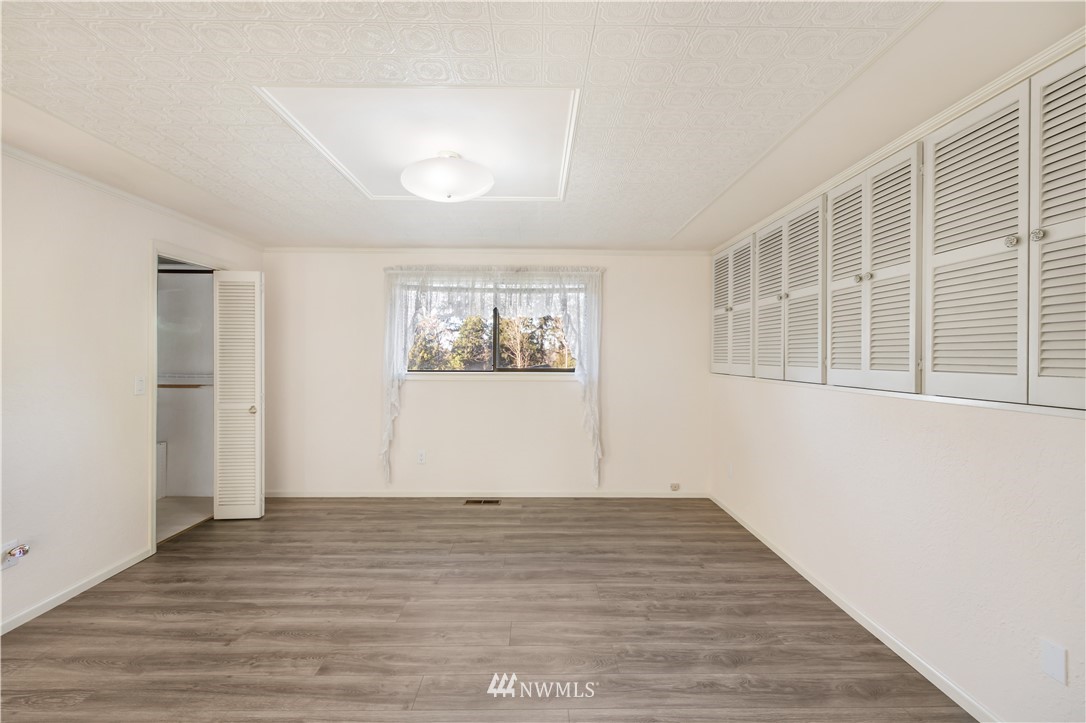 2012 Jones Circle Southeast Renton, WA 98055 - Photo 23 of 25 a view of empty room with wooden floor and fan