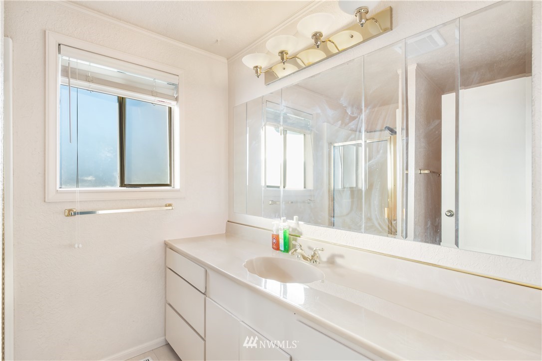 2012 Jones Circle Southeast Renton, WA 98055 - Photo 25 of 25 a bathroom with a granite countertop sink and a mirror