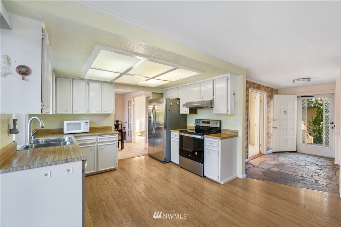 2012 Jones Circle Southeast Renton, WA 98055 - Photo 4 of 25 a kitchen with a refrigerator stove top oven and sink