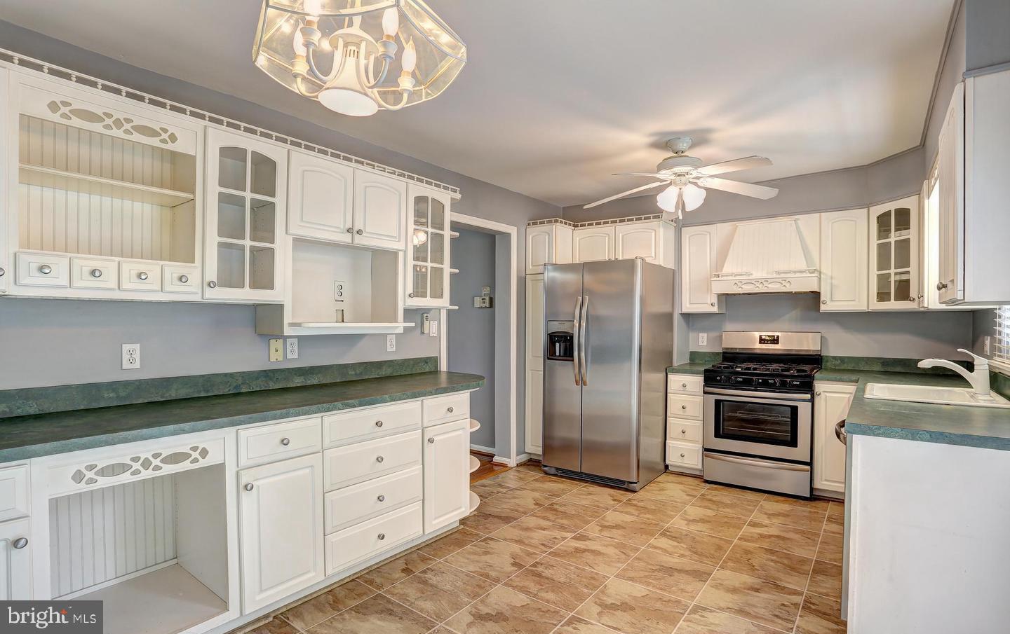5 Cardor Court, Unit 5 Nottingham, MD 21236 - Photo 4 of 11 a kitchen with granite countertop a stove and a refrigerator