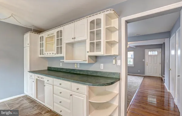 a kitchen with granite countertop white cabinets and sink