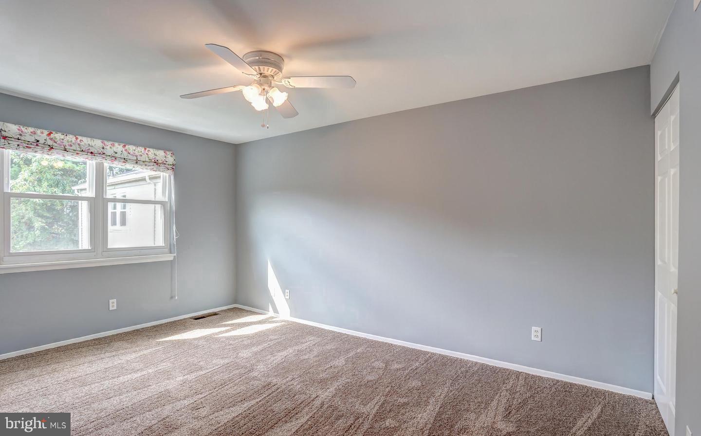 5 Cardor Court, Unit 5 Nottingham, MD 21236 - Photo 8 of 11 an empty room with a window and a ceiling fan