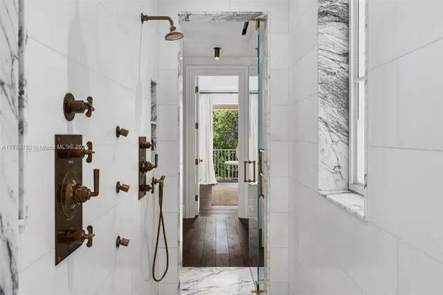 a bedroom with furniture and a large window