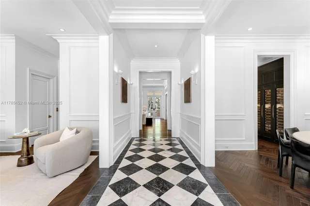 a living room with furniture potted plant and a large window