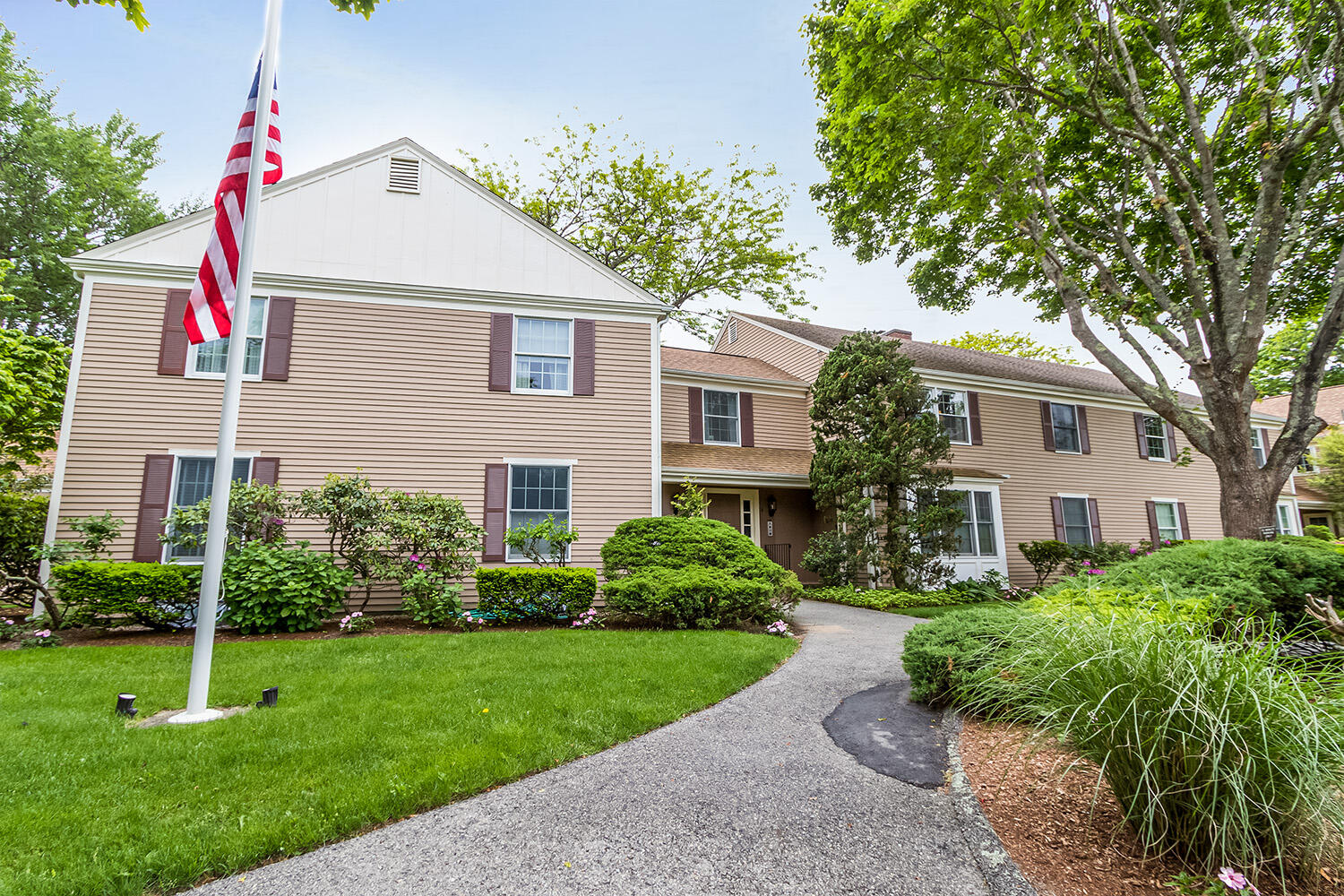 39 Tower Hill Road, Unit 4C Osterville, MA 02655 - Photo 1 of 23 a front view of a house with a yard