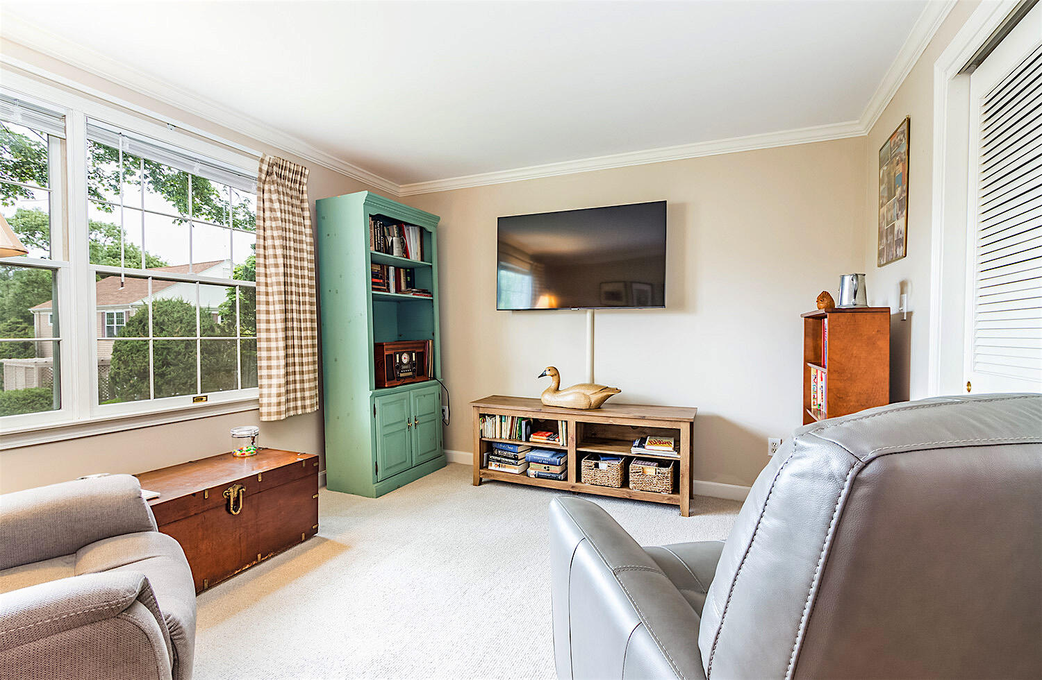 39 Tower Hill Road, Unit 4C Osterville, MA 02655 - Photo 18 of 23 a living room with furniture a flat screen tv and a large window