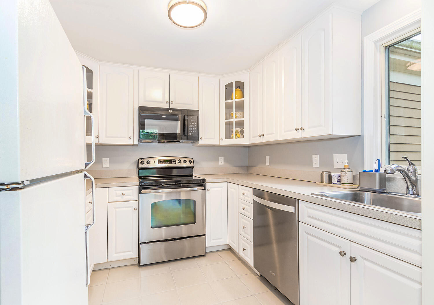 39 Tower Hill Road, Unit 4C Osterville, MA 02655 - Photo 8 of 23 a kitchen with a stove top oven sink and cabinets