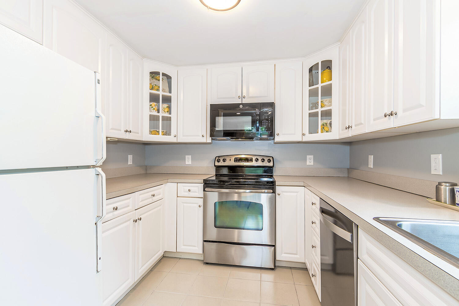 39 Tower Hill Road, Unit 4C Osterville, MA 02655 - Photo 9 of 23 a kitchen with white cabinets and appliances