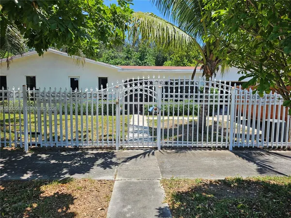 a view of a house with a small yard and plants