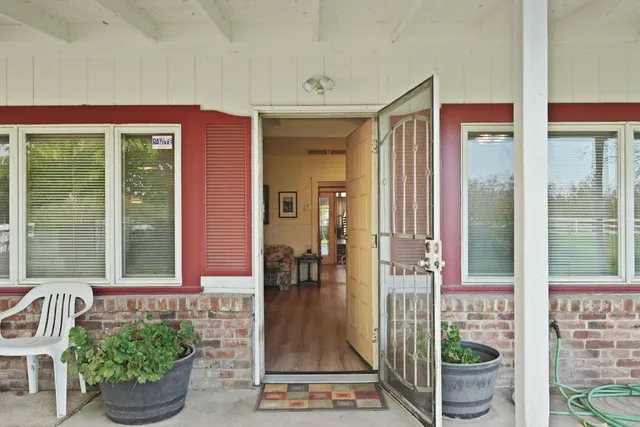 a bathroom with a sink a toilet a large mirror a bathtub and shower