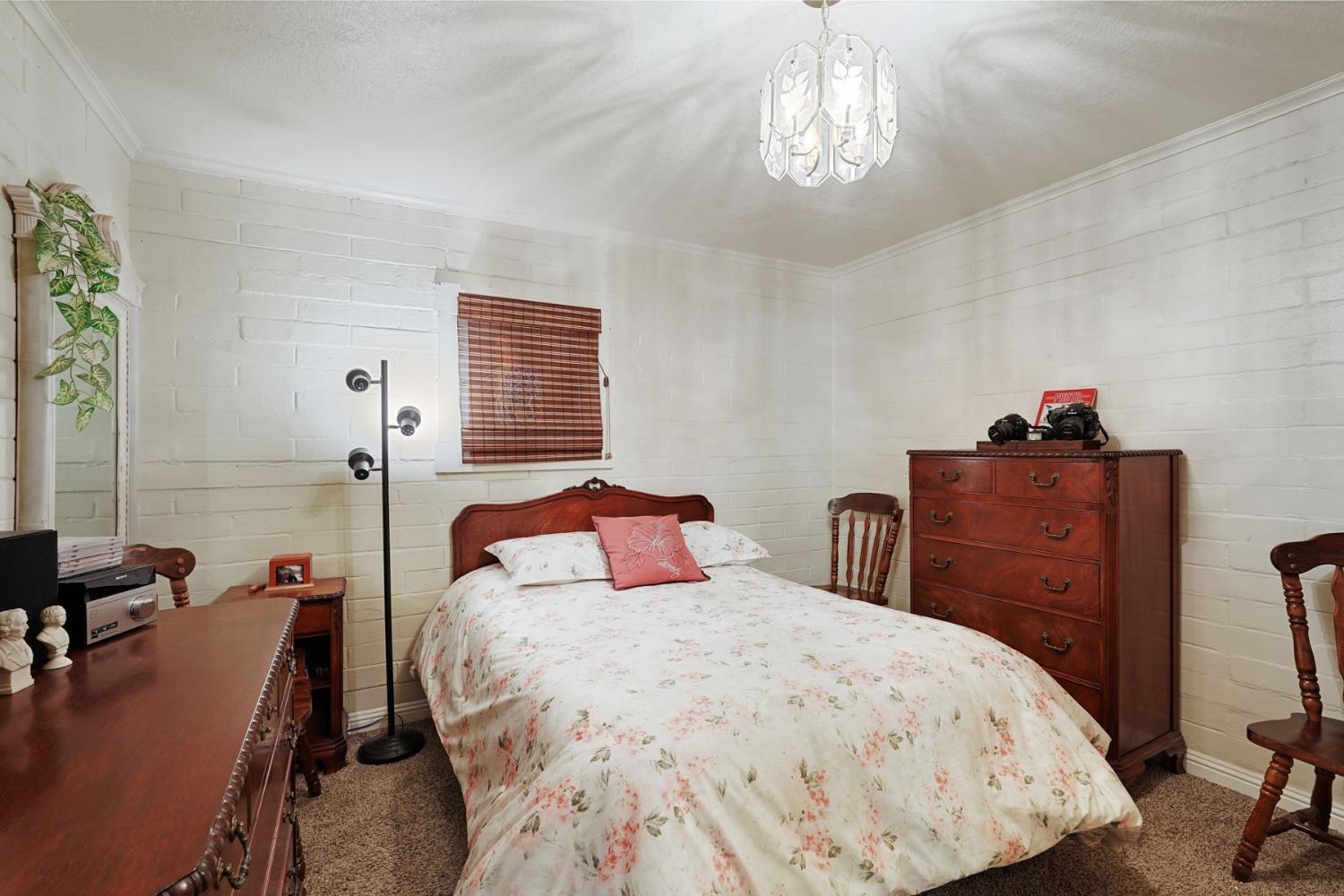 5766 Alpine Road Stockton, CA 95215 - Photo 35 of 99 a bedroom with a bed and wooden floor