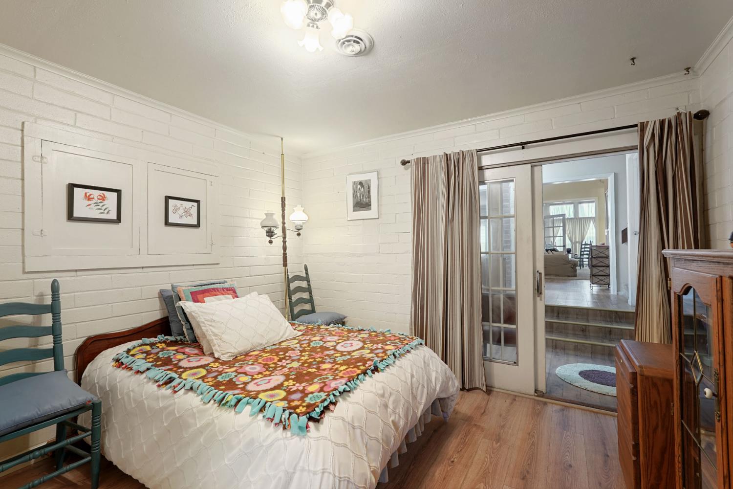 5766 Alpine Road Stockton, CA 95215 - Photo 38 of 99 a bedroom with a bed and wooden floor