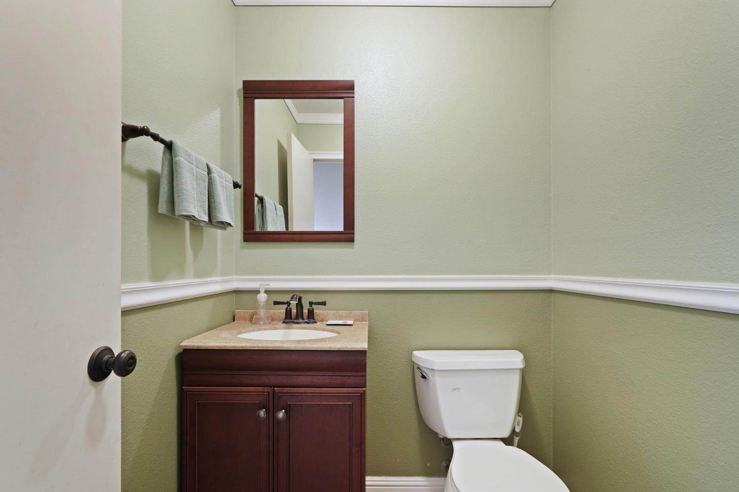 5766 Alpine Road Stockton, CA 95215 - Photo 60 of 99 a bathroom with a toilet sink and mirror