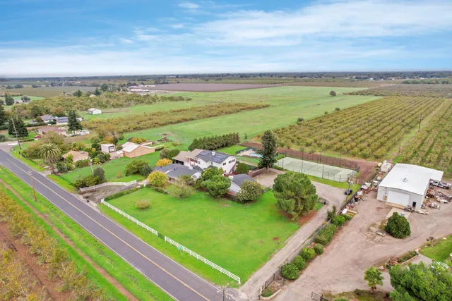 a view of a house with a yard and sitting area