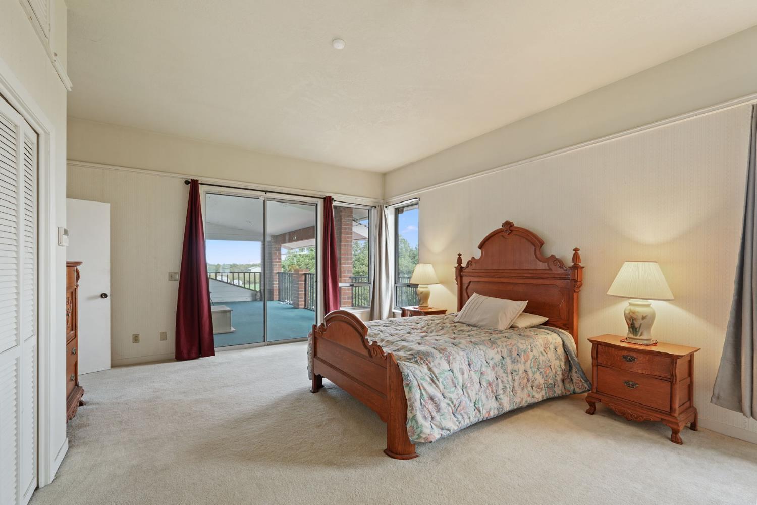 5766 Alpine Road Stockton, CA 95215 - Photo 76 of 99 a bedroom with a bed and a lamp on table