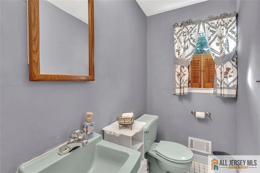 93 Remmey Street Fords, NJ 08863 - Photo 15 of 27 a bathroom with a toilet sink and mirror