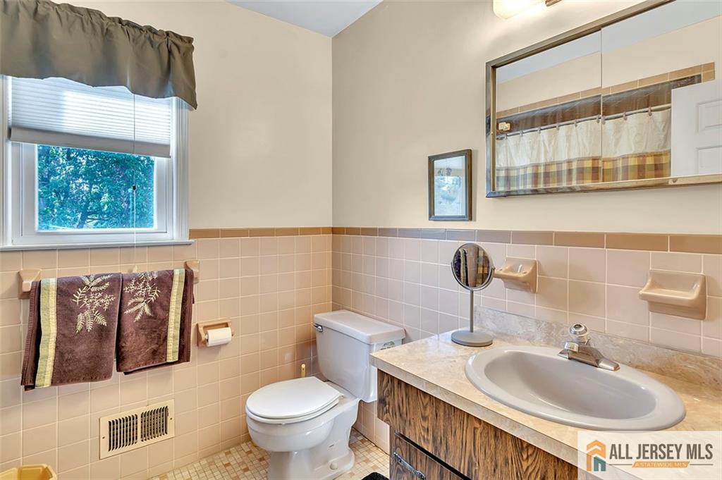 93 Remmey Street Fords, NJ 08863 - Photo 16 of 27 a bathroom with a sink and a toilet