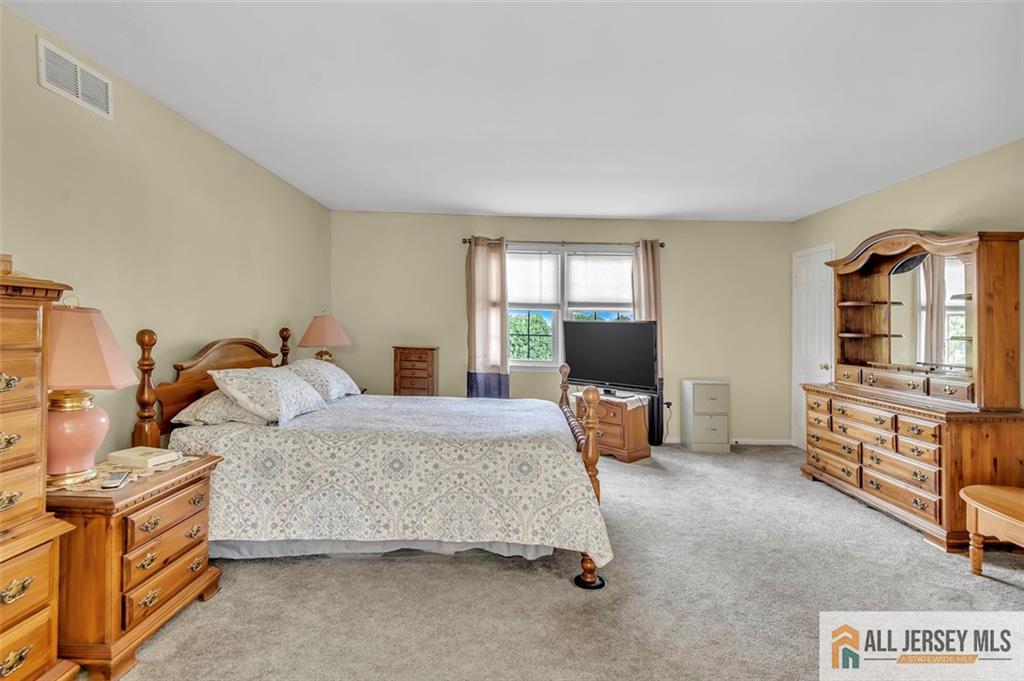 93 Remmey Street Fords, NJ 08863 - Photo 19 of 27 a bedroom with furniture and flat screen tv