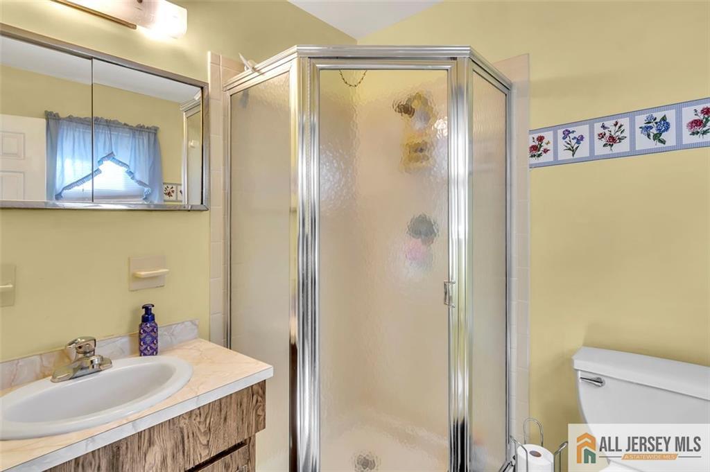 93 Remmey Street Fords, NJ 08863 - Photo 20 of 27 a bathroom with a sink and a mirror