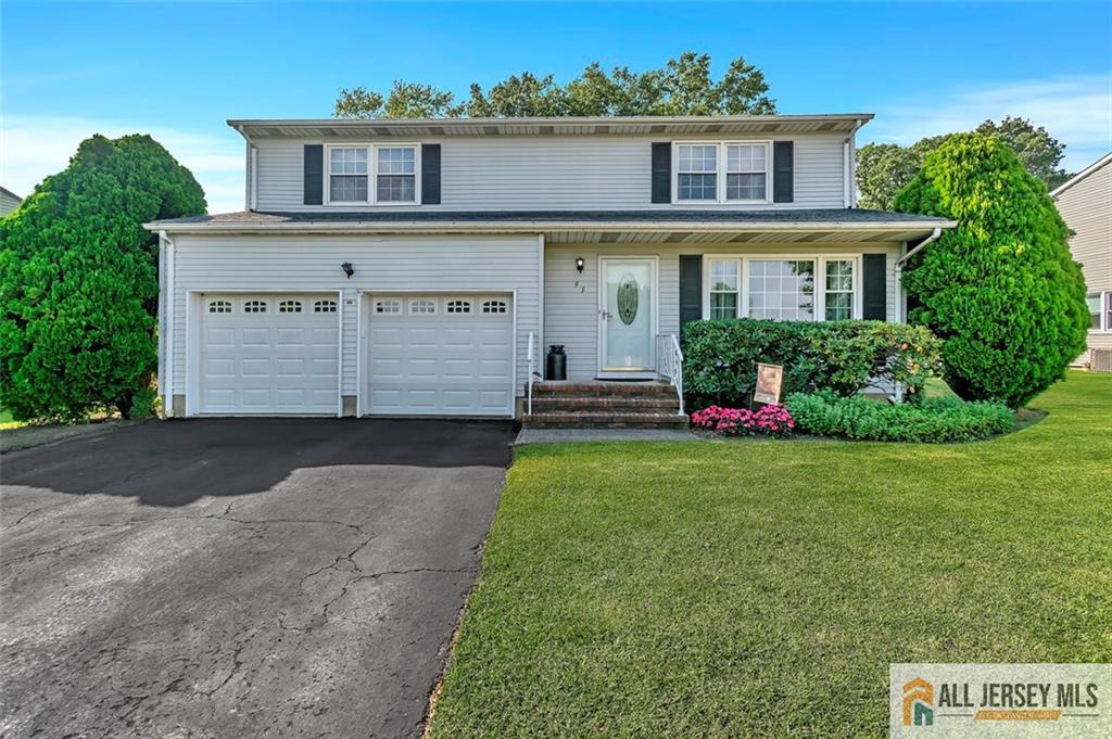93 Remmey Street Fords, NJ 08863 - Photo 2 of 27 a front view of a house with a yard and garage