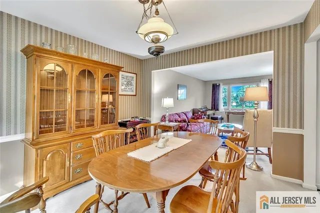 a view of a dining room with furniture wooden floor and chandelier