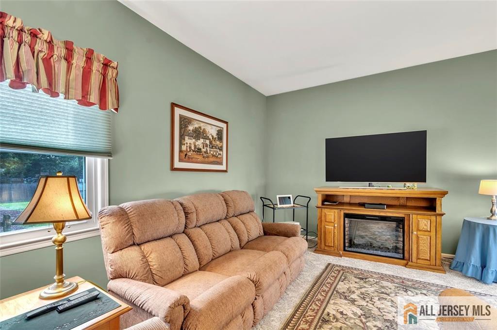 93 Remmey Street Fords, NJ 08863 - Photo 10 of 27 a living room with furniture a flat screen tv and a fireplace