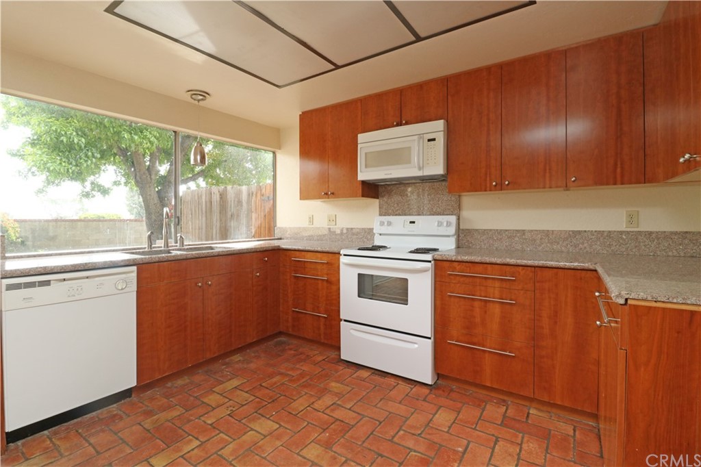 712 Earlham Drive Claremont, CA 91711 - Photo 6 of 14 a kitchen with a stove cabinets and a sink