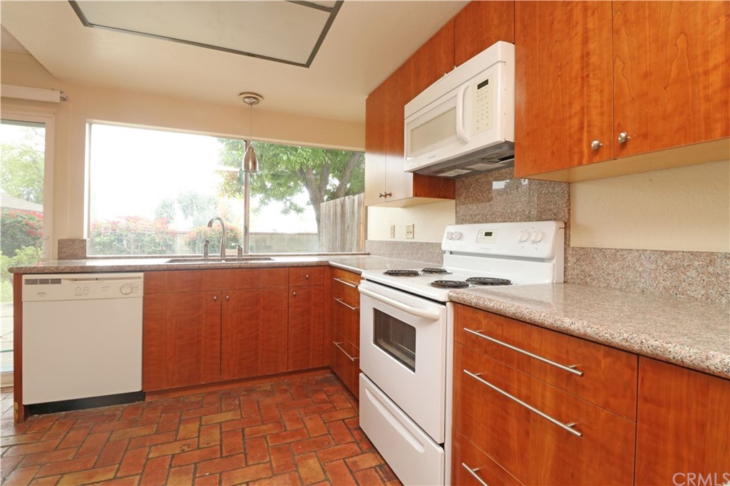 712 Earlham Drive Claremont, CA 91711 - Photo 7 of 14 a kitchen with stainless steel appliances granite countertop a stove a sink and a refrigerator