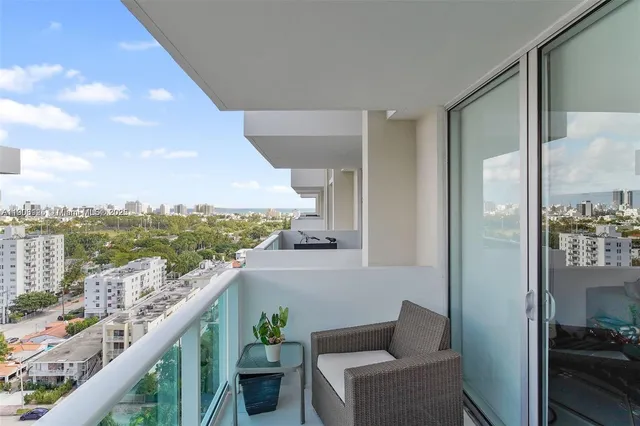 a balcony with furniture and city view