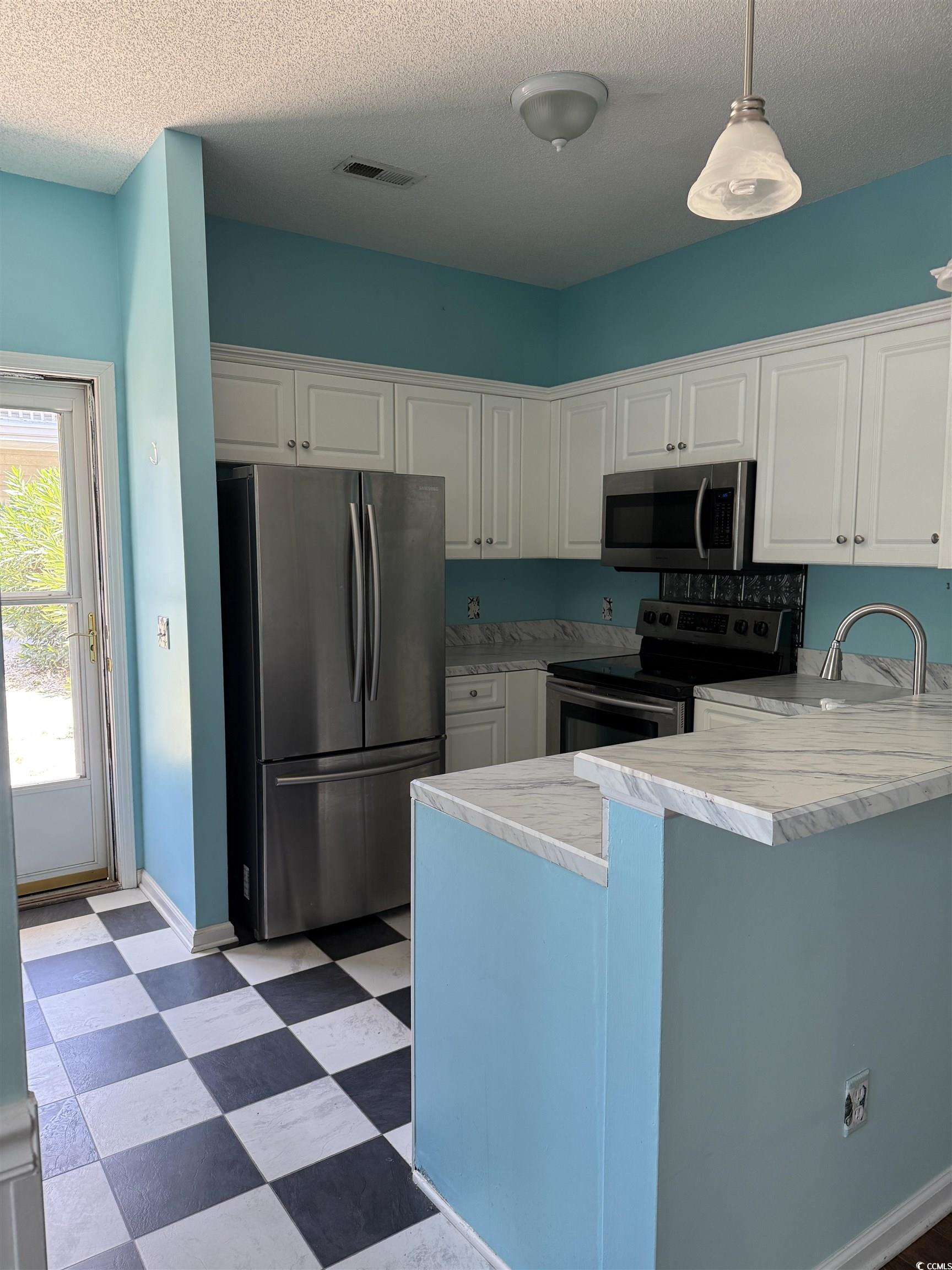 4206 Sweetwater Boulevard Murrells Inlet, SC 29576 - Photo 3 of 10 Kitchen with stainless steel appliances, a peninsu