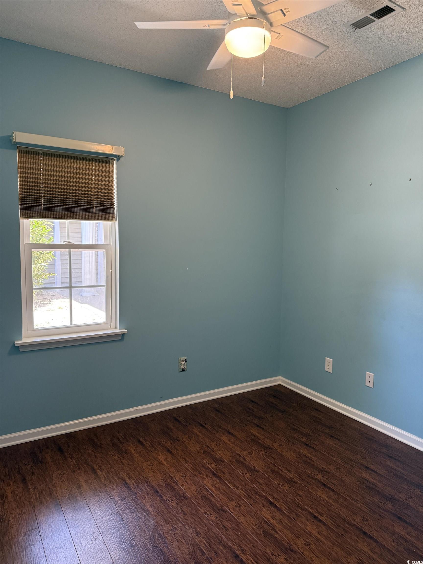 4206 Sweetwater Boulevard Murrells Inlet, SC 29576 - Photo 7 of 10 Spare room featuring a textured ceiling, dark wood