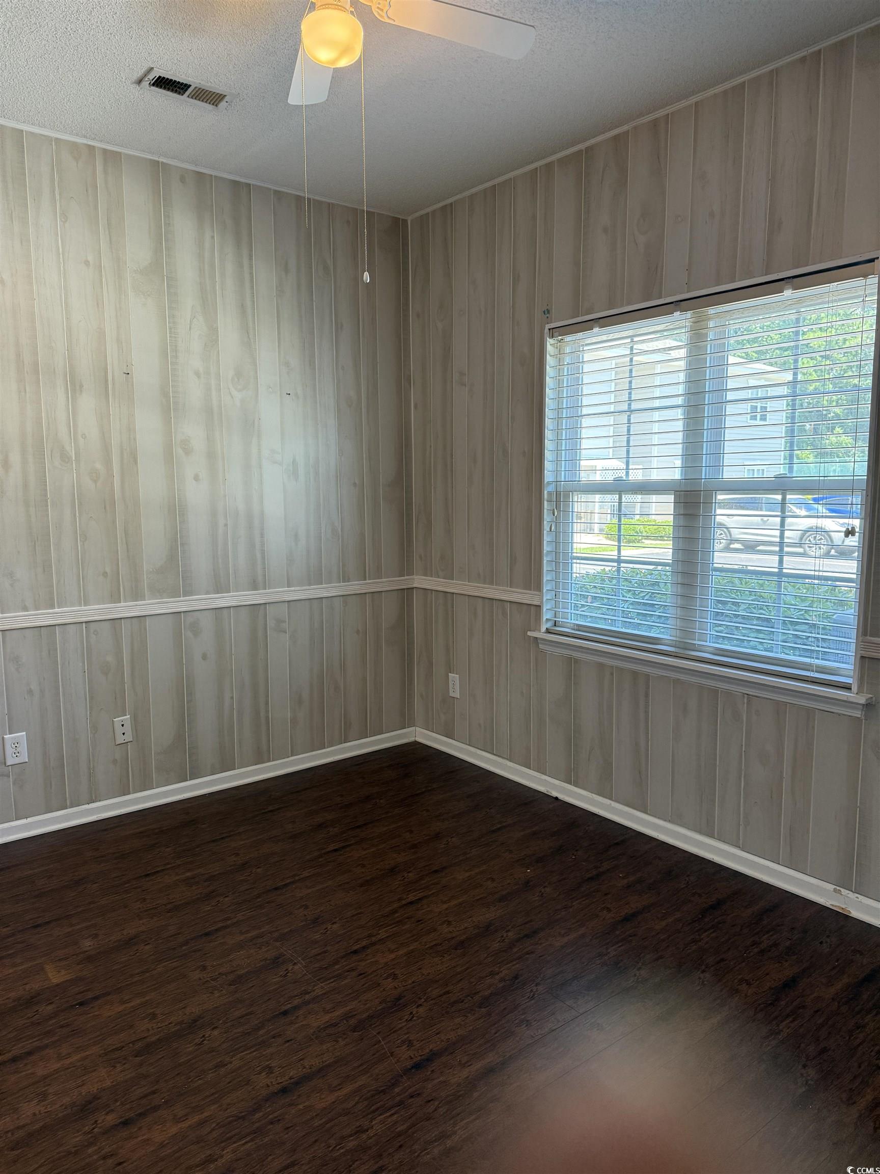 4206 Sweetwater Boulevard Murrells Inlet, SC 29576 - Photo 9 of 10 Unfurnished room with a textured ceiling, dark woo
